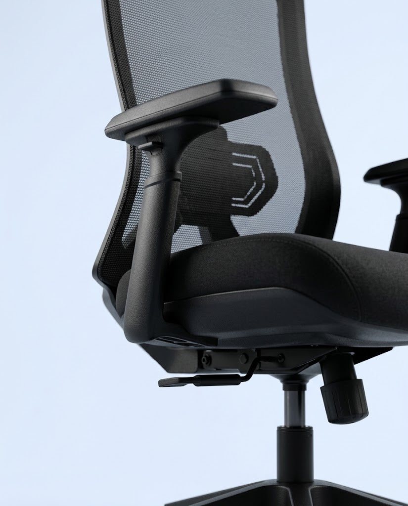 Close-up of a black mesh office chair showing the backrest, armrest, padded seat, and base against a pale blue background.